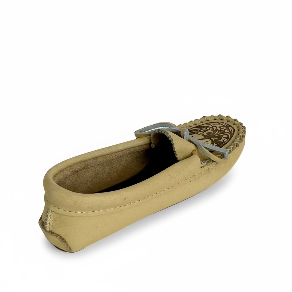 Beige loafer shoe with decorative sole on a white background