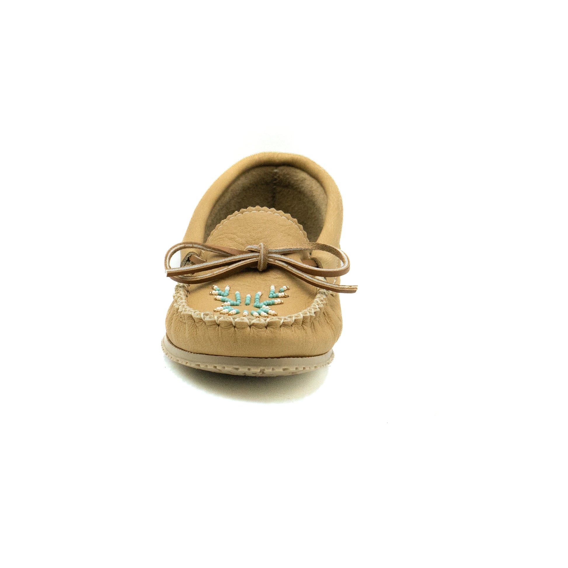 Tan moccasin shoe with decorative element on a white background