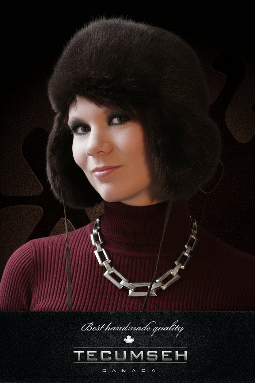 Woman wearing a black fur hat with 'Tecumseh Canada' branding on a dark background