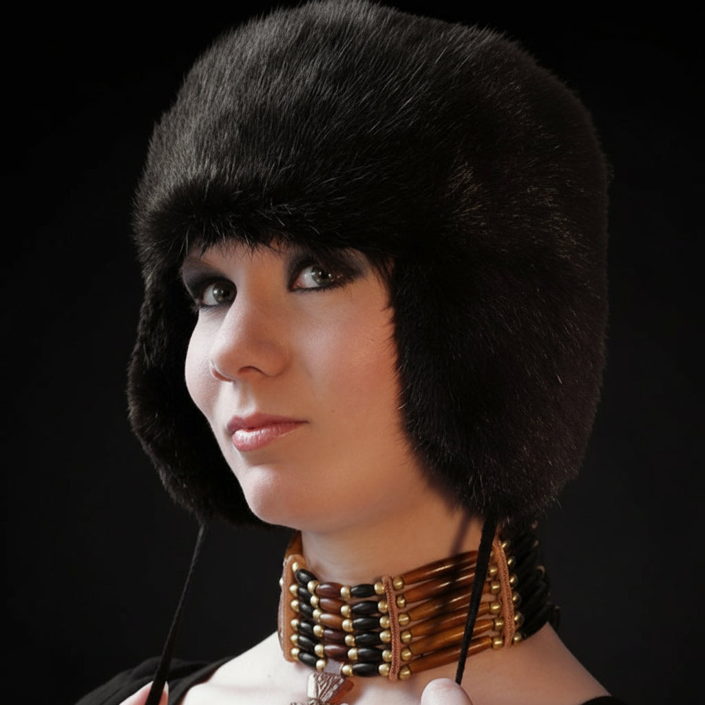 Woman wearing a black fur hat with a dark background