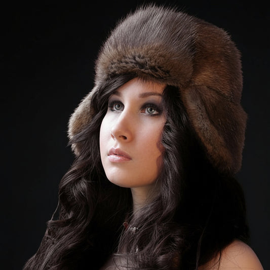 Woman wearing a brown fur hat against a dark background