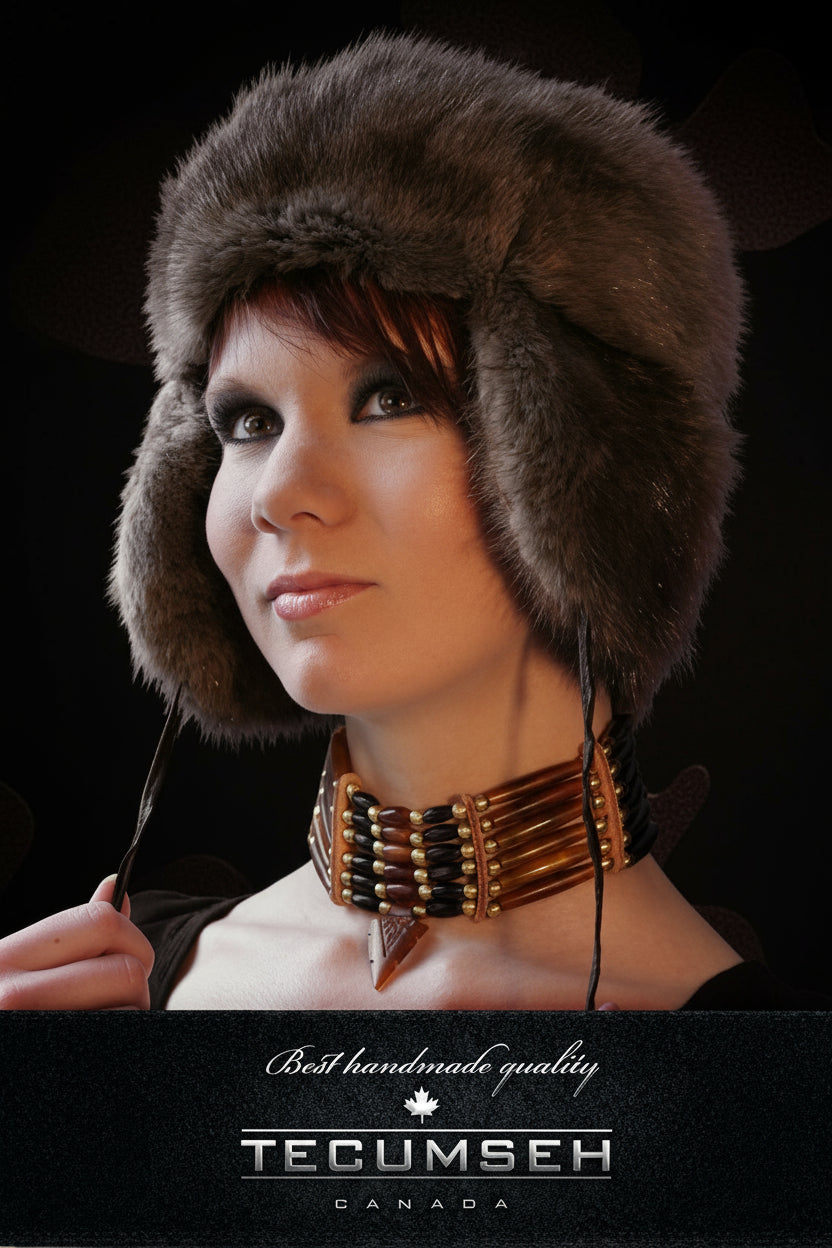 Woman wearing a fur hat with a dark background, featuring the Tecumseh brand.