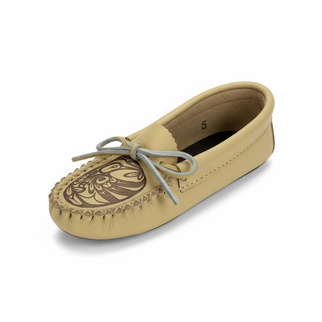 Beige moccasin shoe with a decorative design on a white background