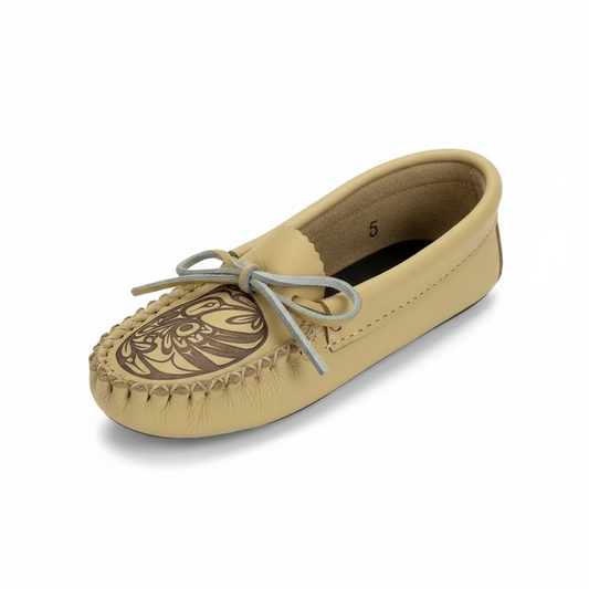 Beige moccasin shoe with a decorative design on a white background