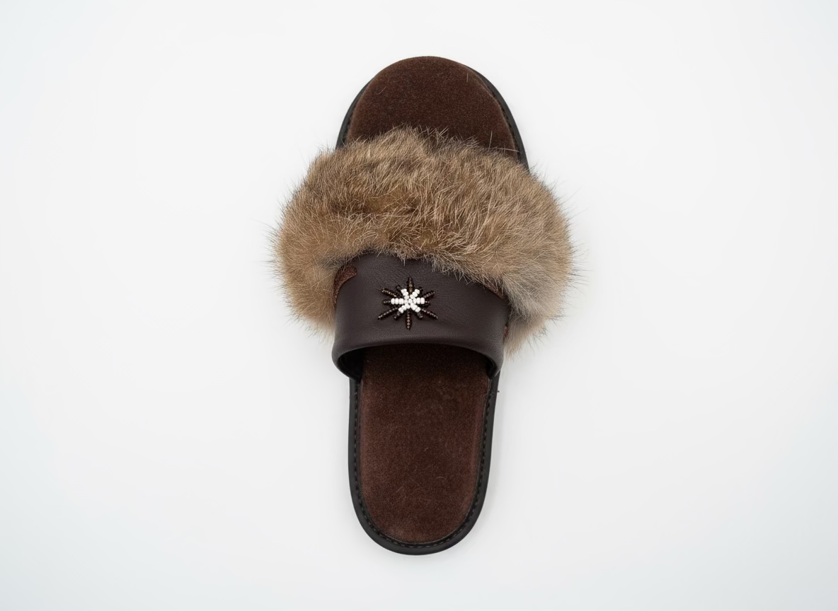 Brown sandal with fur strap and decorative star on a white surface