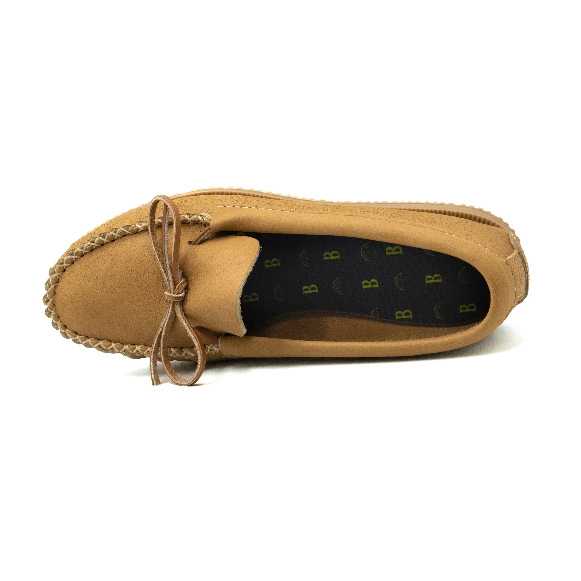 Tan loafer shoe with braided detail on a white background