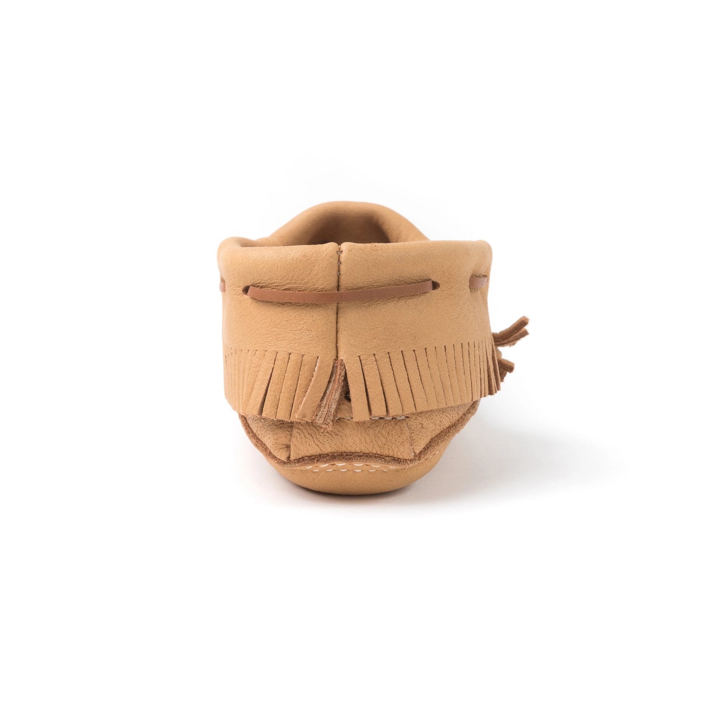 Tan suede shoe with fringes on a white background