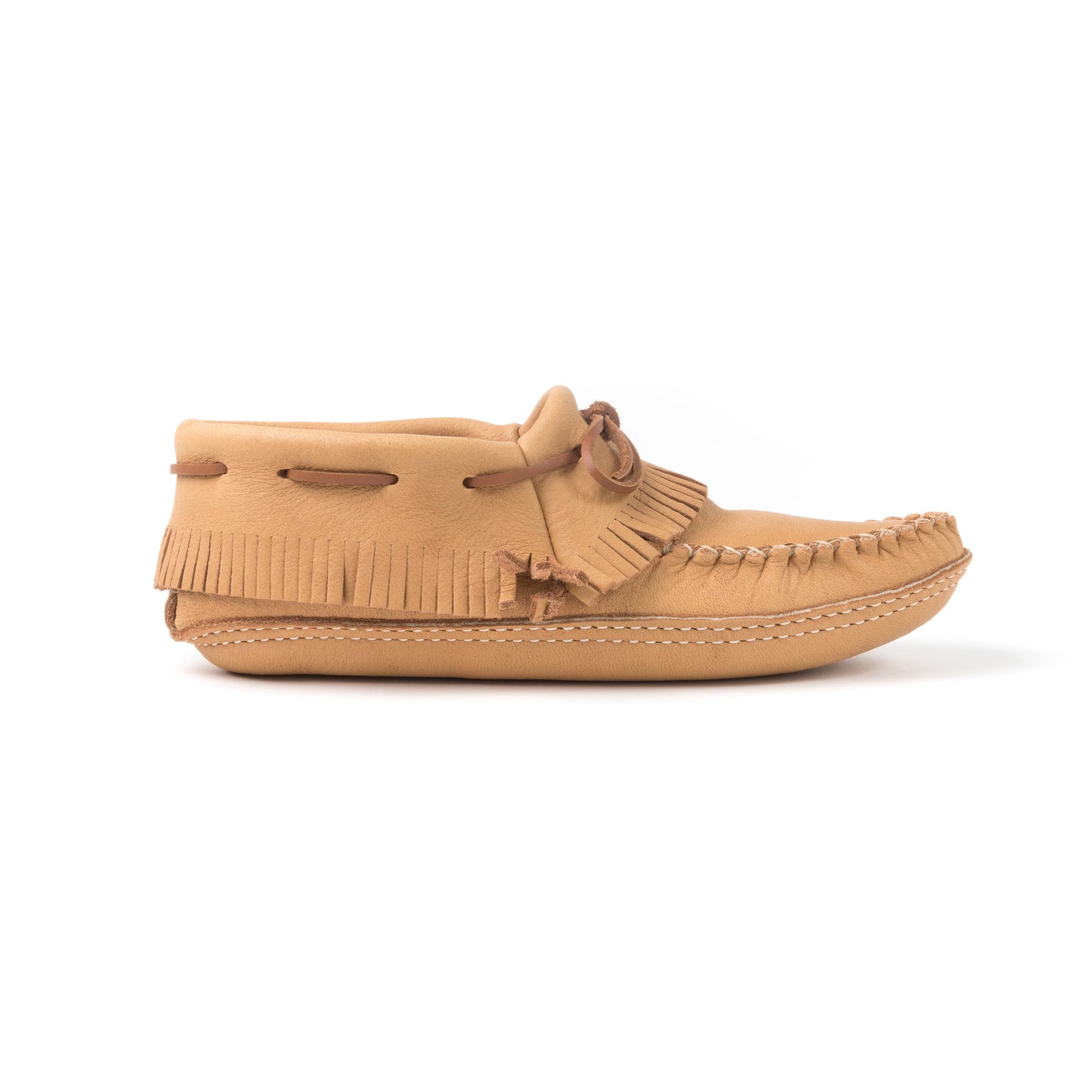 Tan moccasin shoe with fringes on a white background