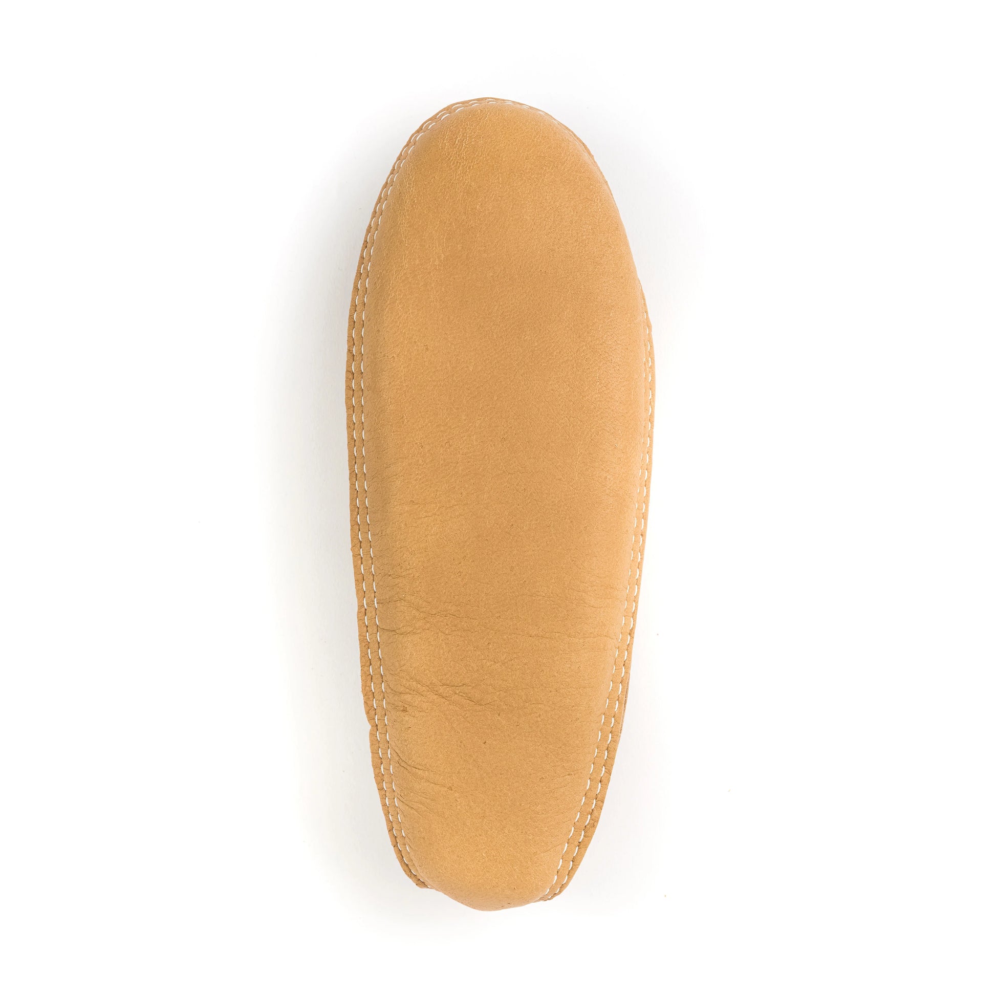 Tan shoe insole on a white background