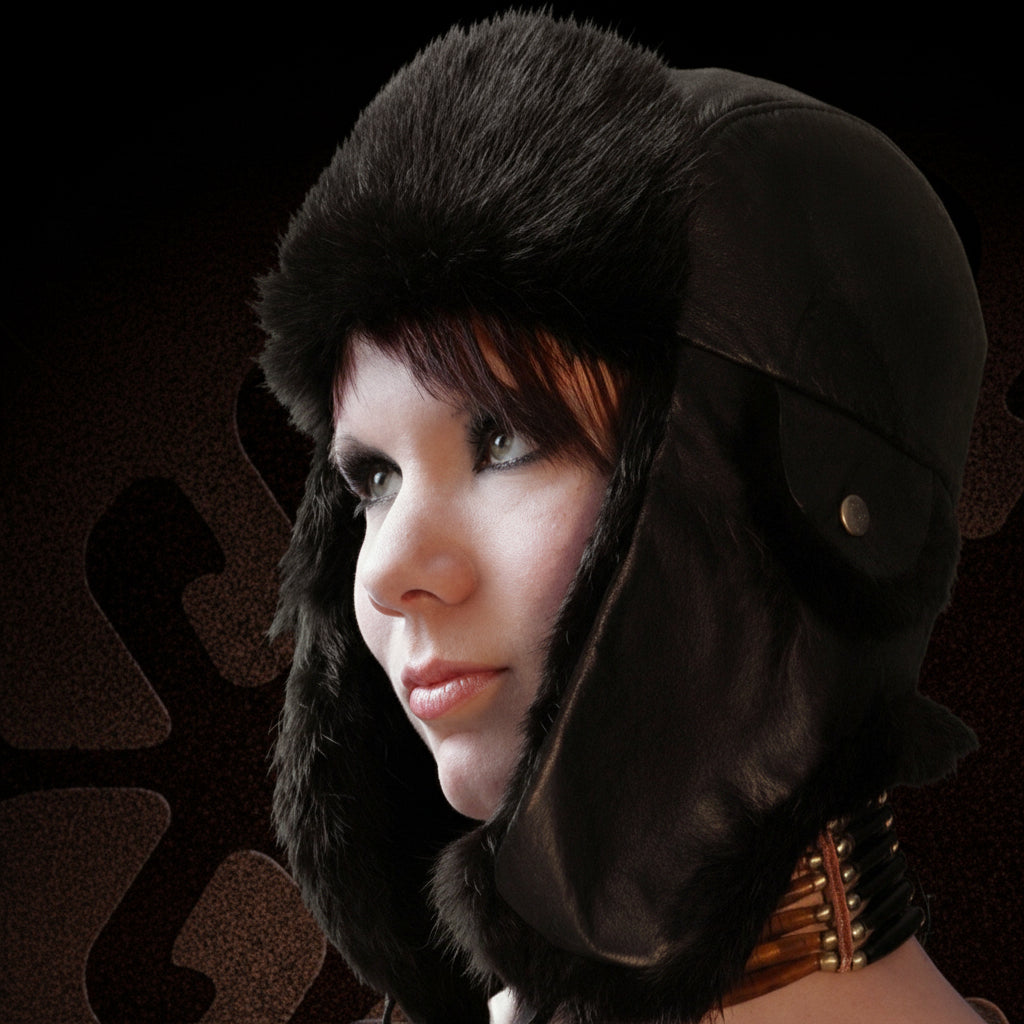 Person wearing a dark fur-lined bomber hat against a dark background