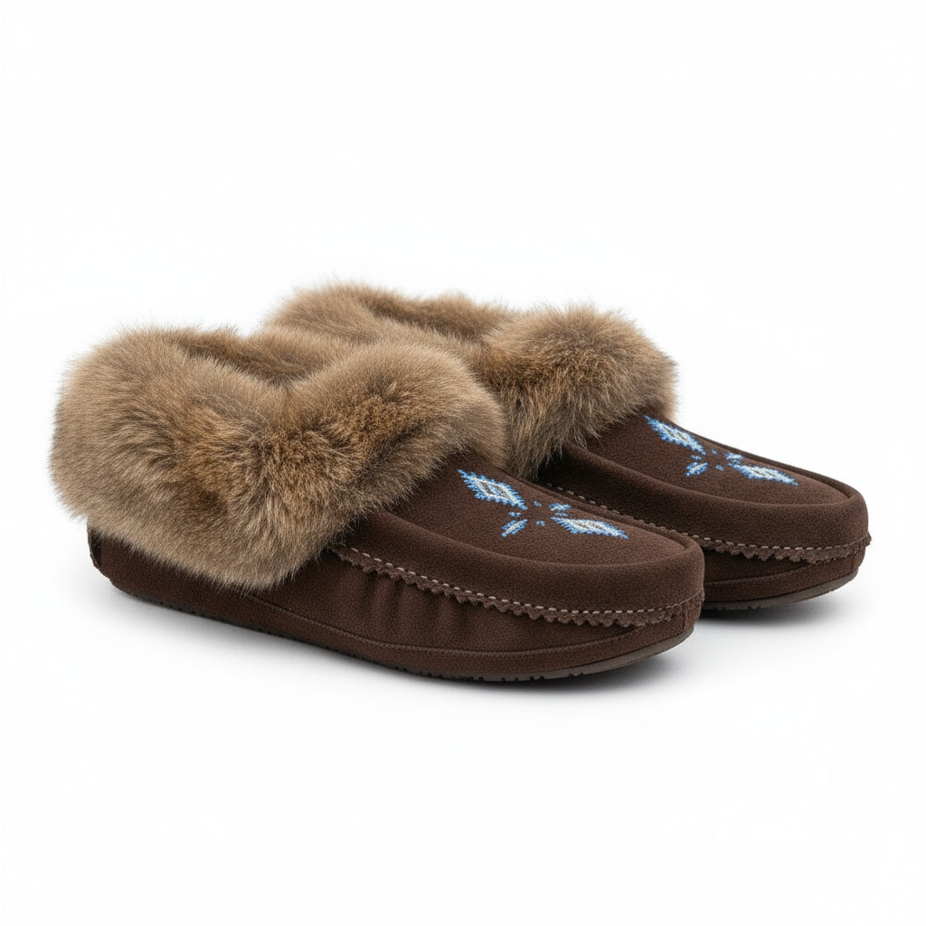 Brown slippers with fur trim worn by a person on a wooden deck.