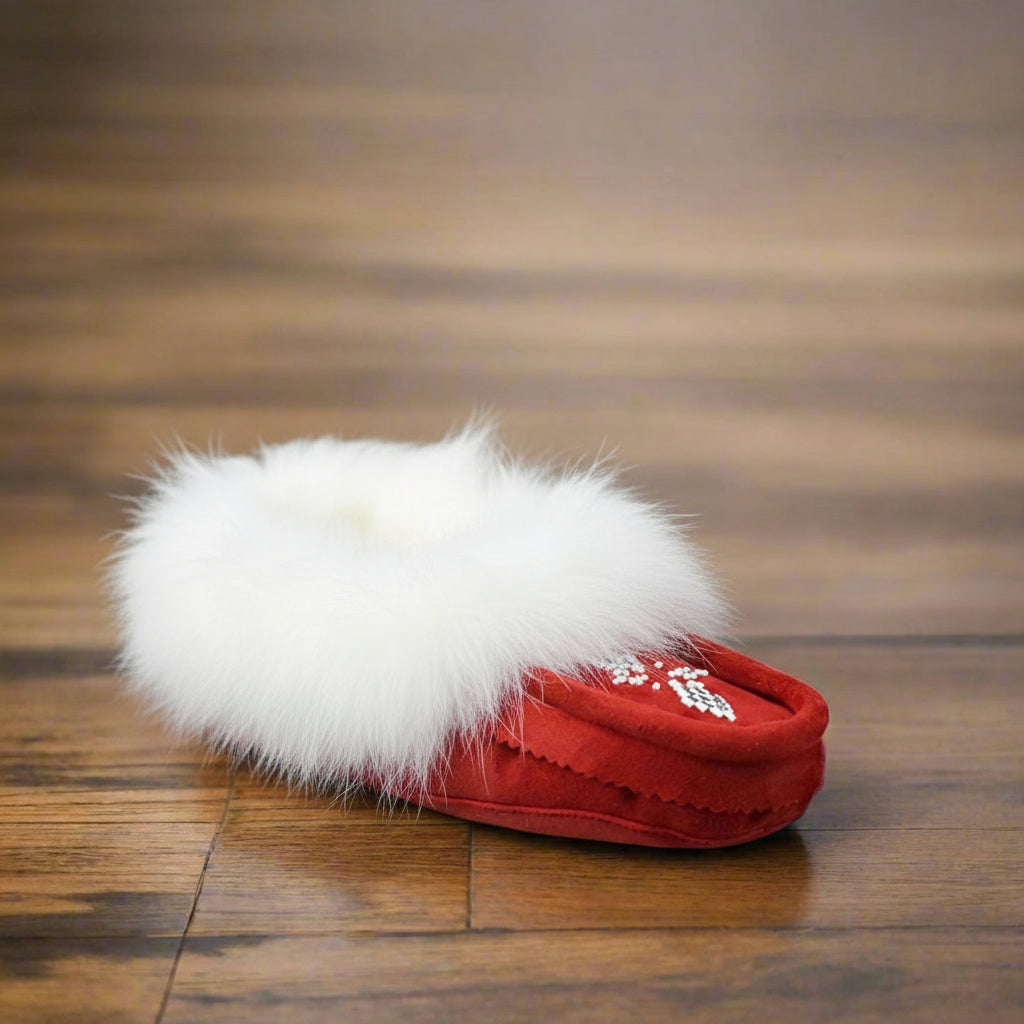 Red slipper with white fur on a wooden floor
