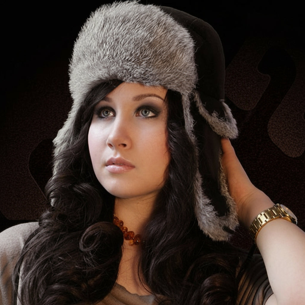 Woman wearing a fur-trimmed hat against a dark background