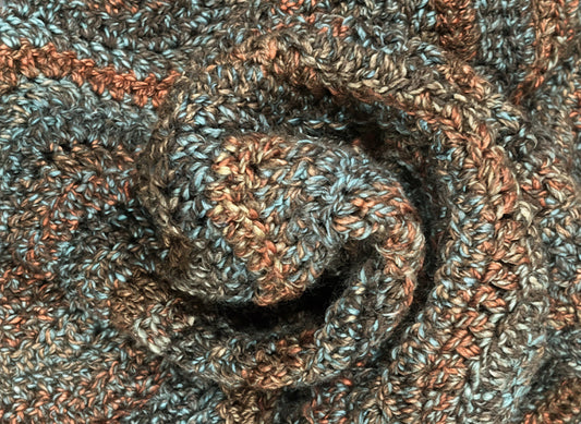 Close-up of a knitted fabric with brown and blue tones.