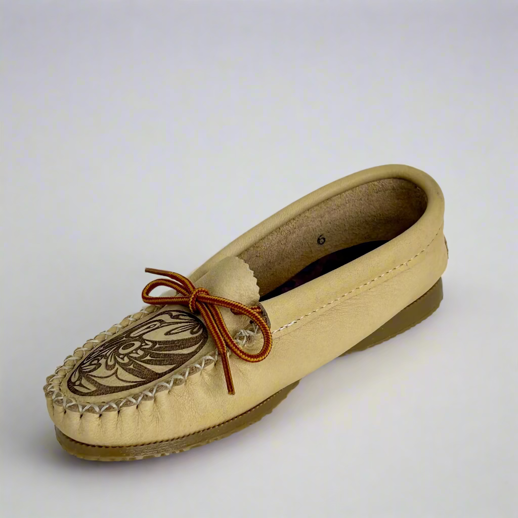 Beige moccasin shoe with brown bow on a white background