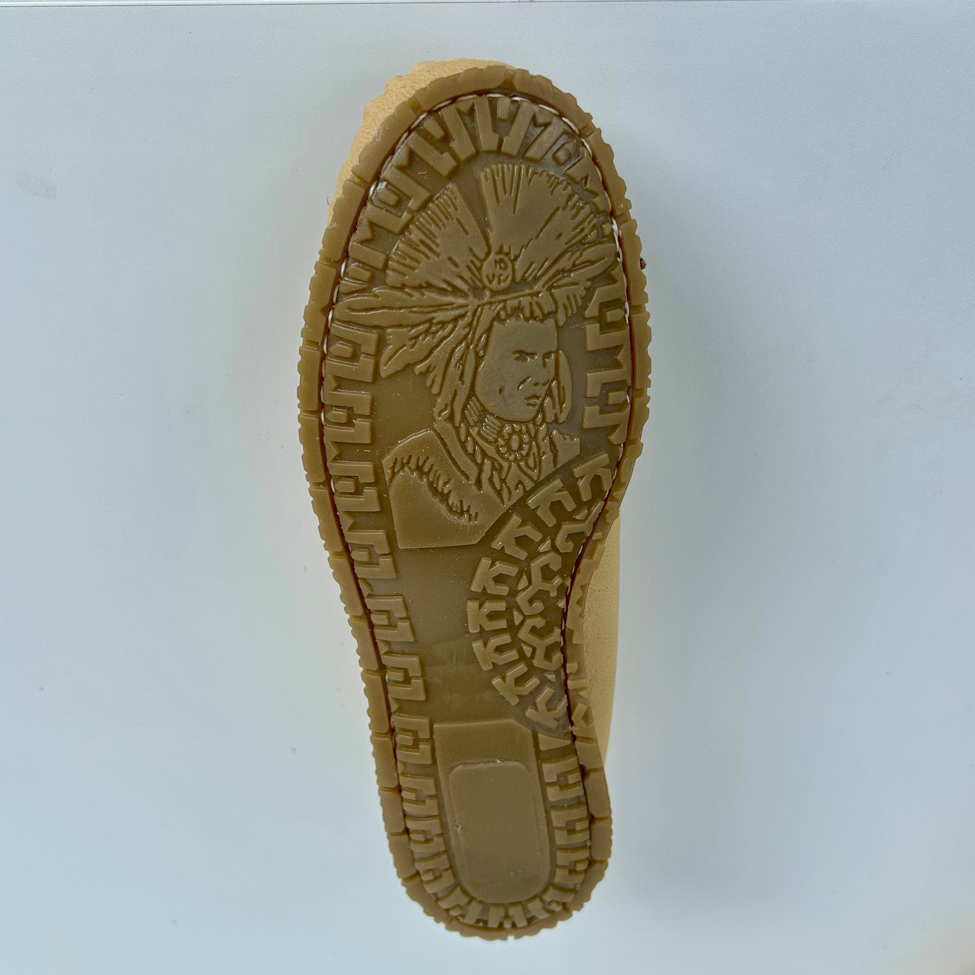 Tan moccasin rubber sole with Indian Chief brand logo on a white background