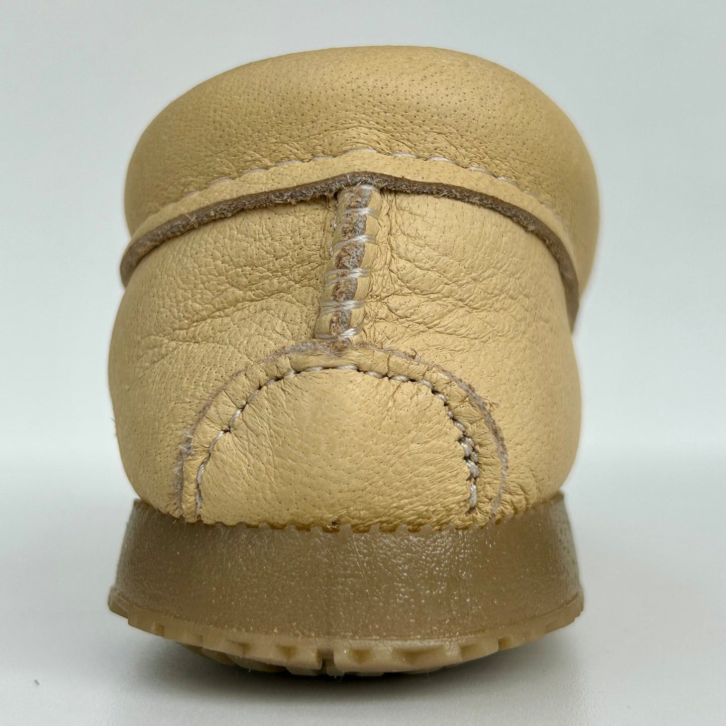 Beige leather moccasin with a white background