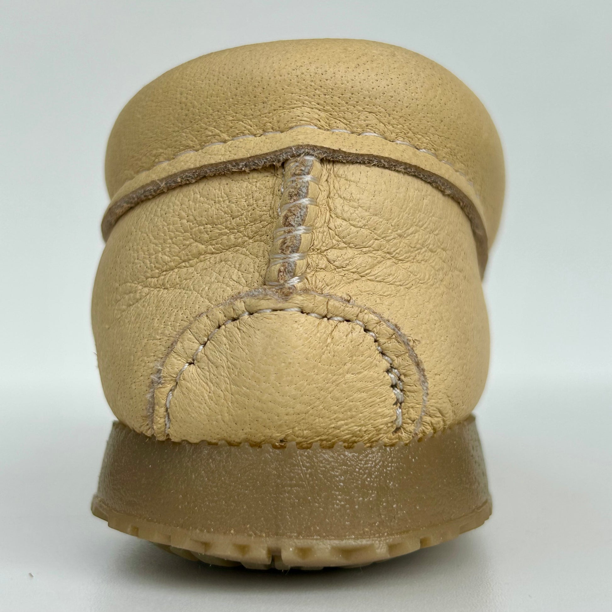 Beige leather moccasin with a white background