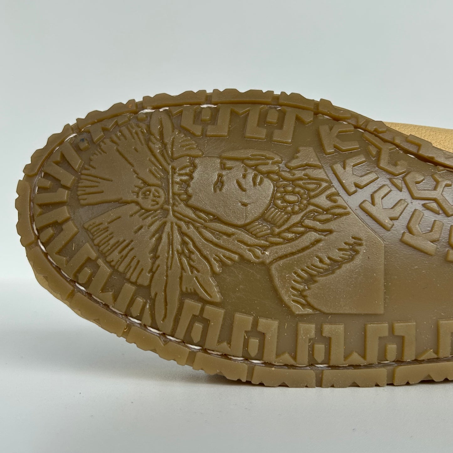 Close-up of a moccasin sole with a detailed design of indian chief on a white background