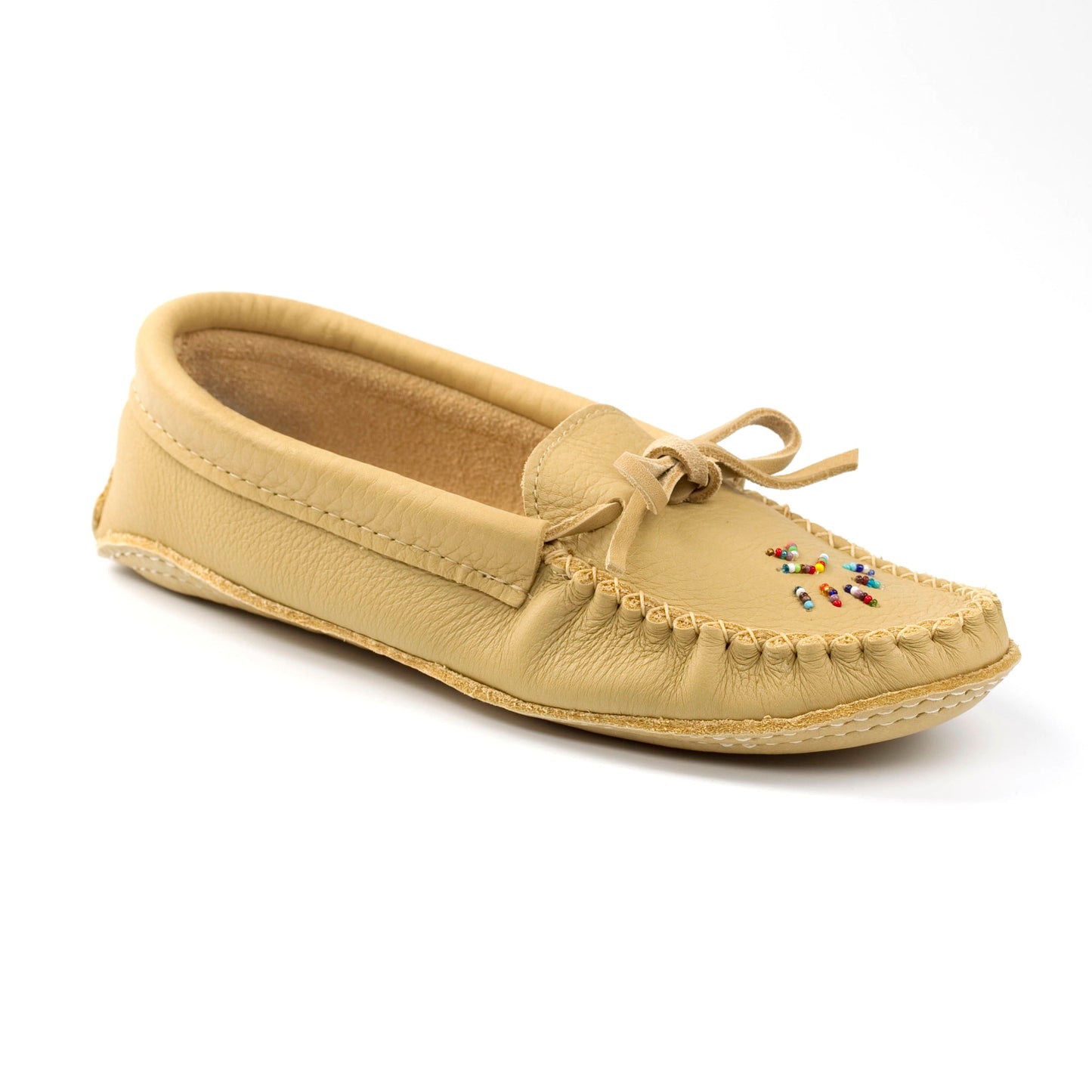 Beige moccasin shoe with decorative elements on a white background