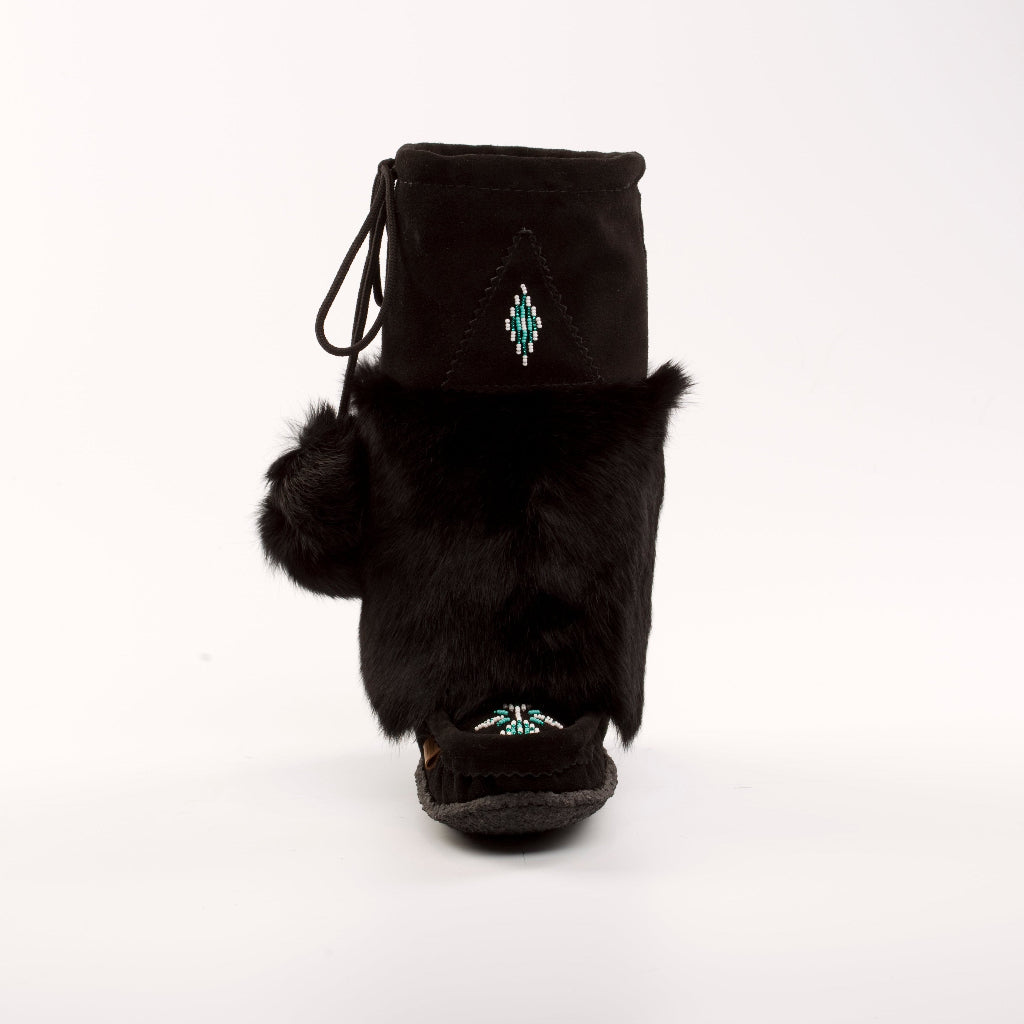 Black fur-lined boot with pom-poms on a white background