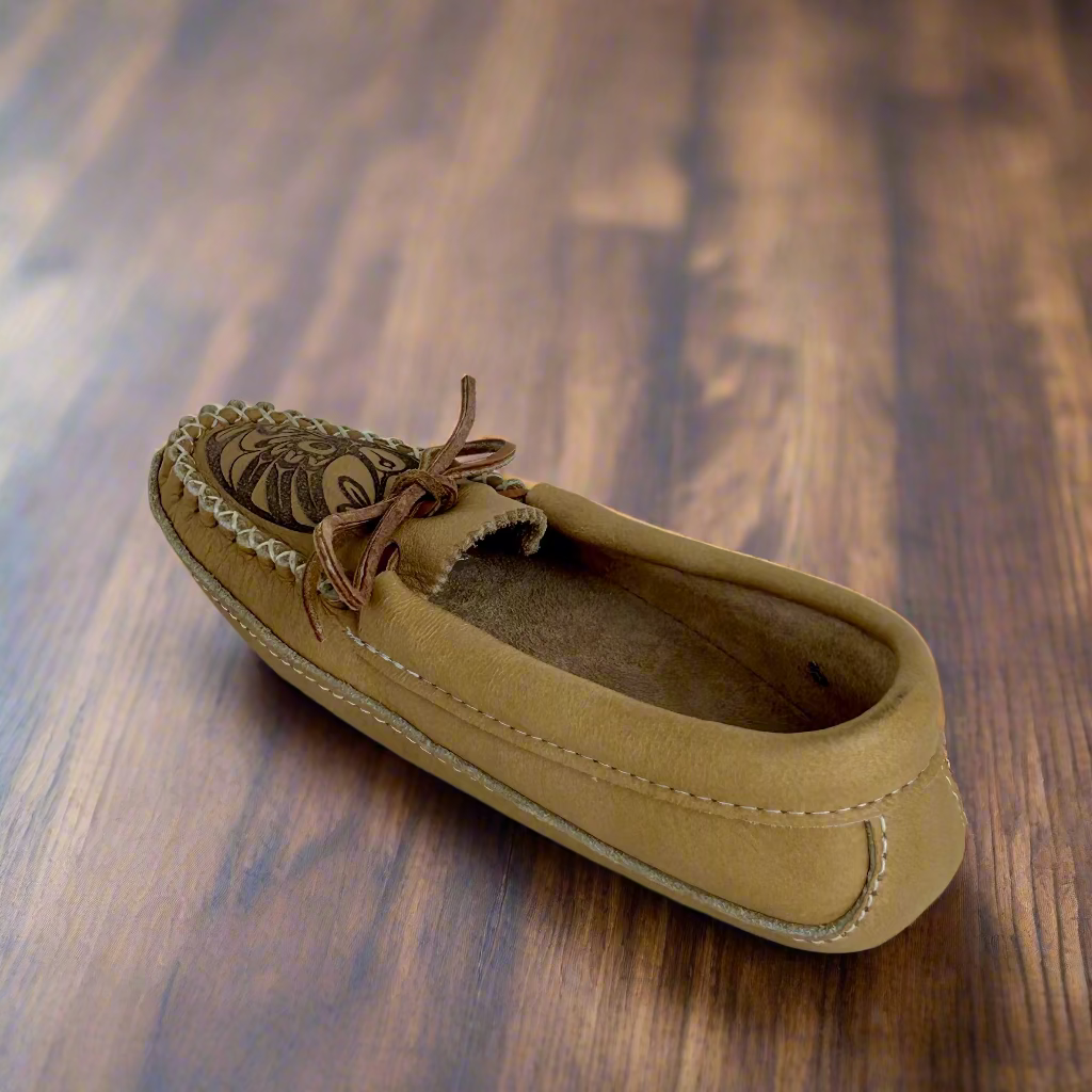 Tan loafer shoe on a wooden surface