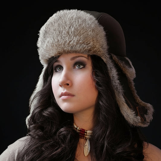 Woman wearing a fur-trimmed hat against a dark background