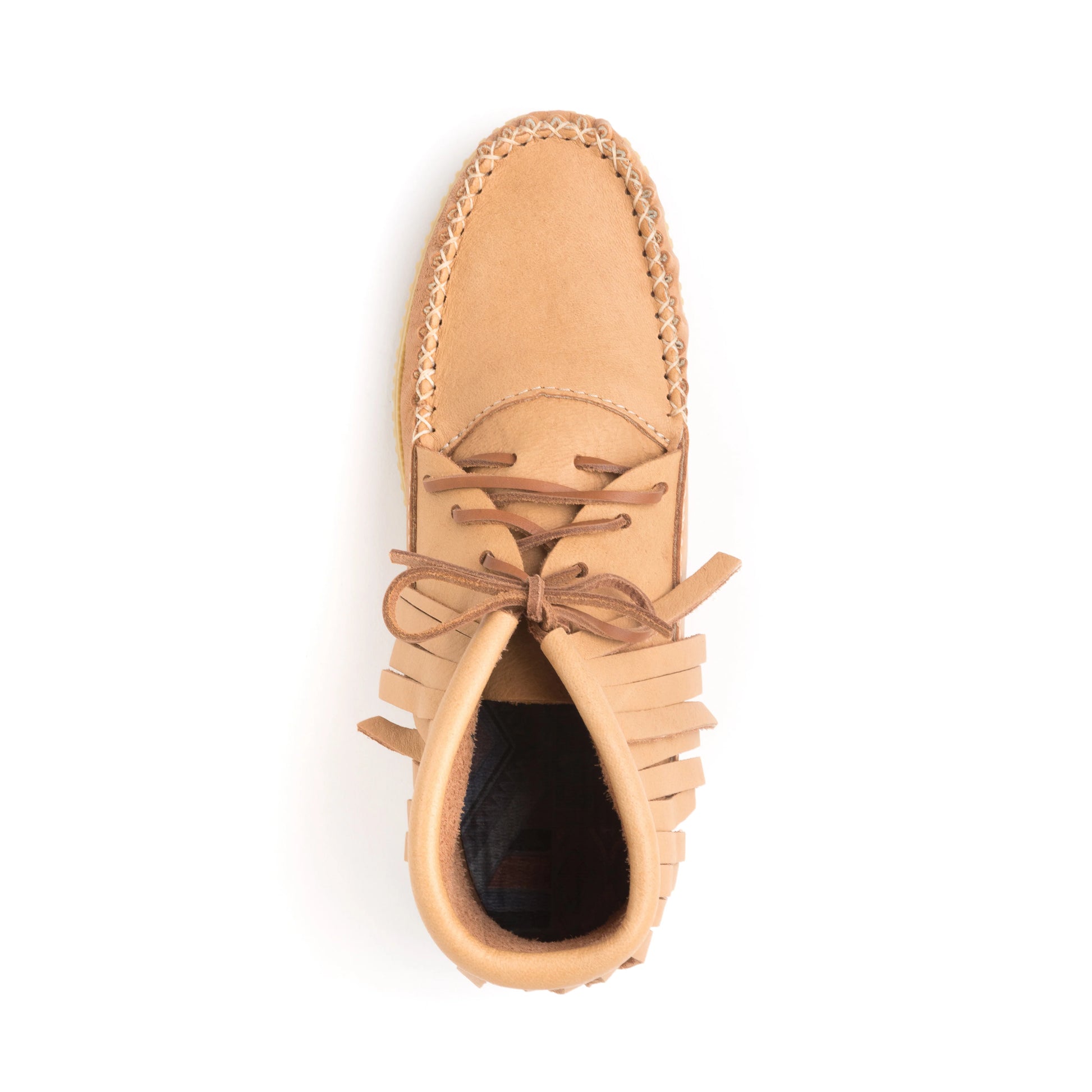 Tan moccasin shoe with fringes on a white background