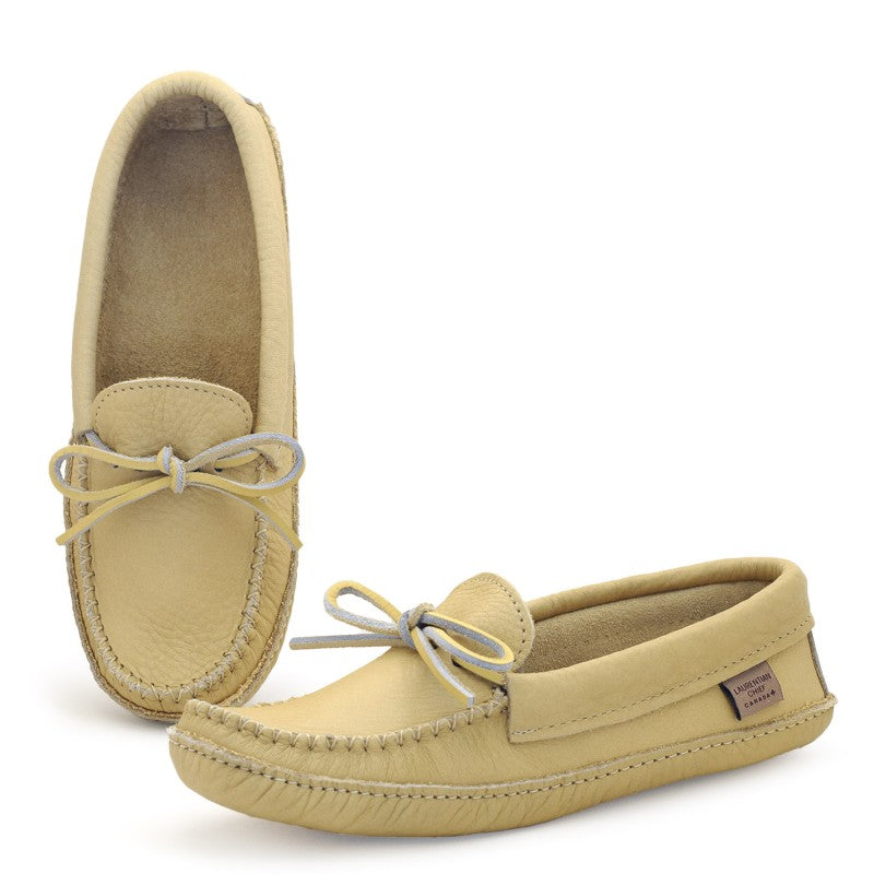 Pair of beige moccasin shoes with white laces on a white background