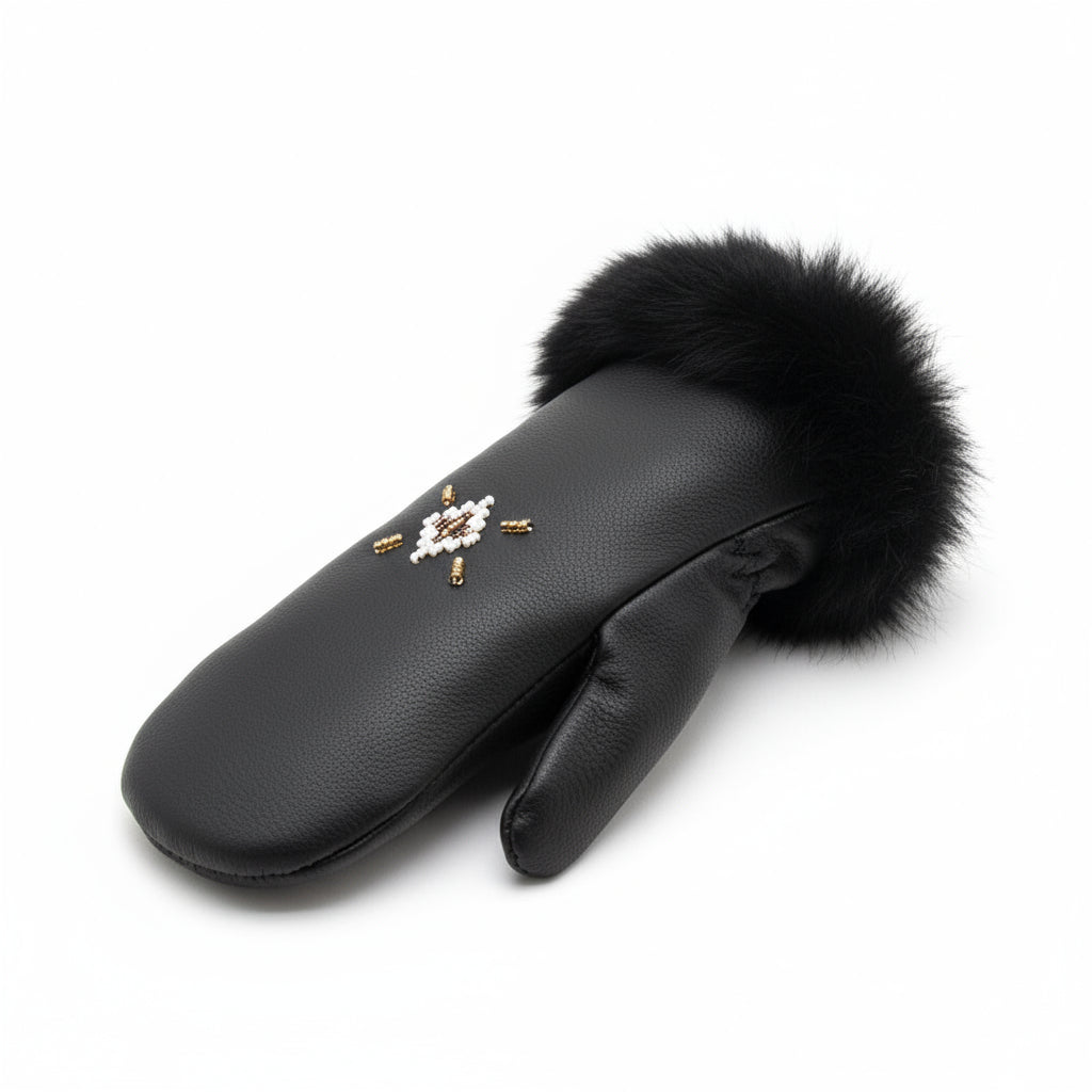 Black leather mittens with fur on a mossy ground