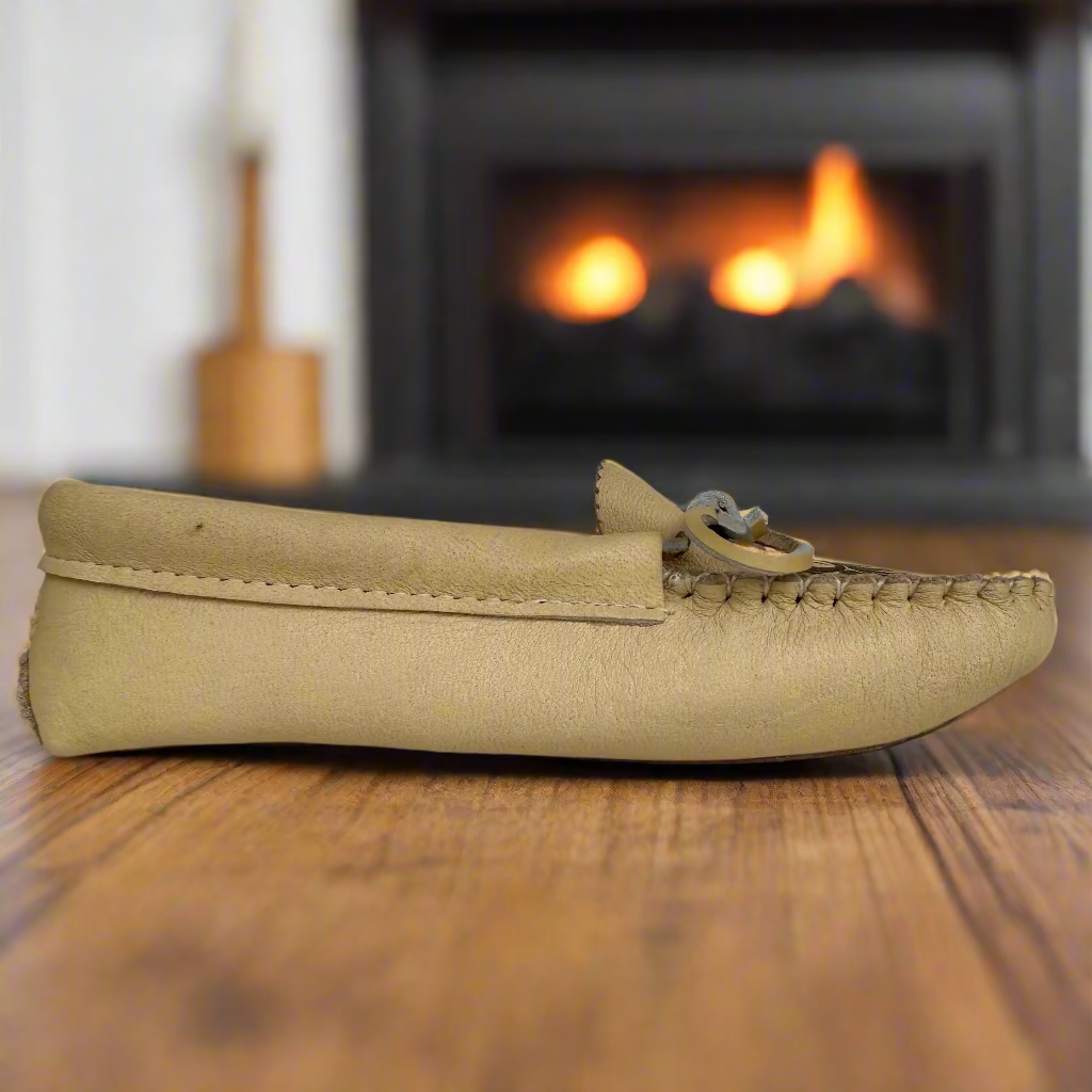 Beige moccasin shoe on a light gray background