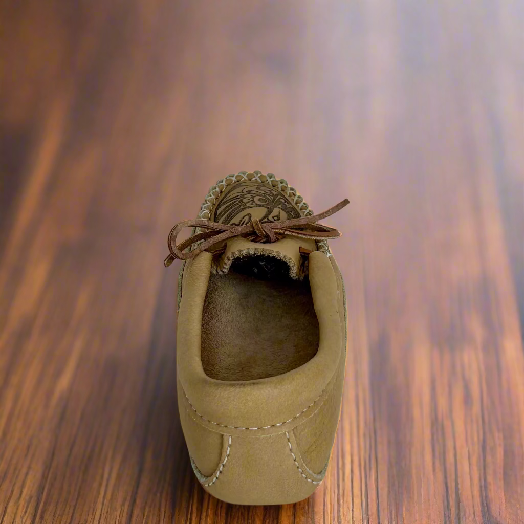 Tan moccasin shoe with brown laces on a white background