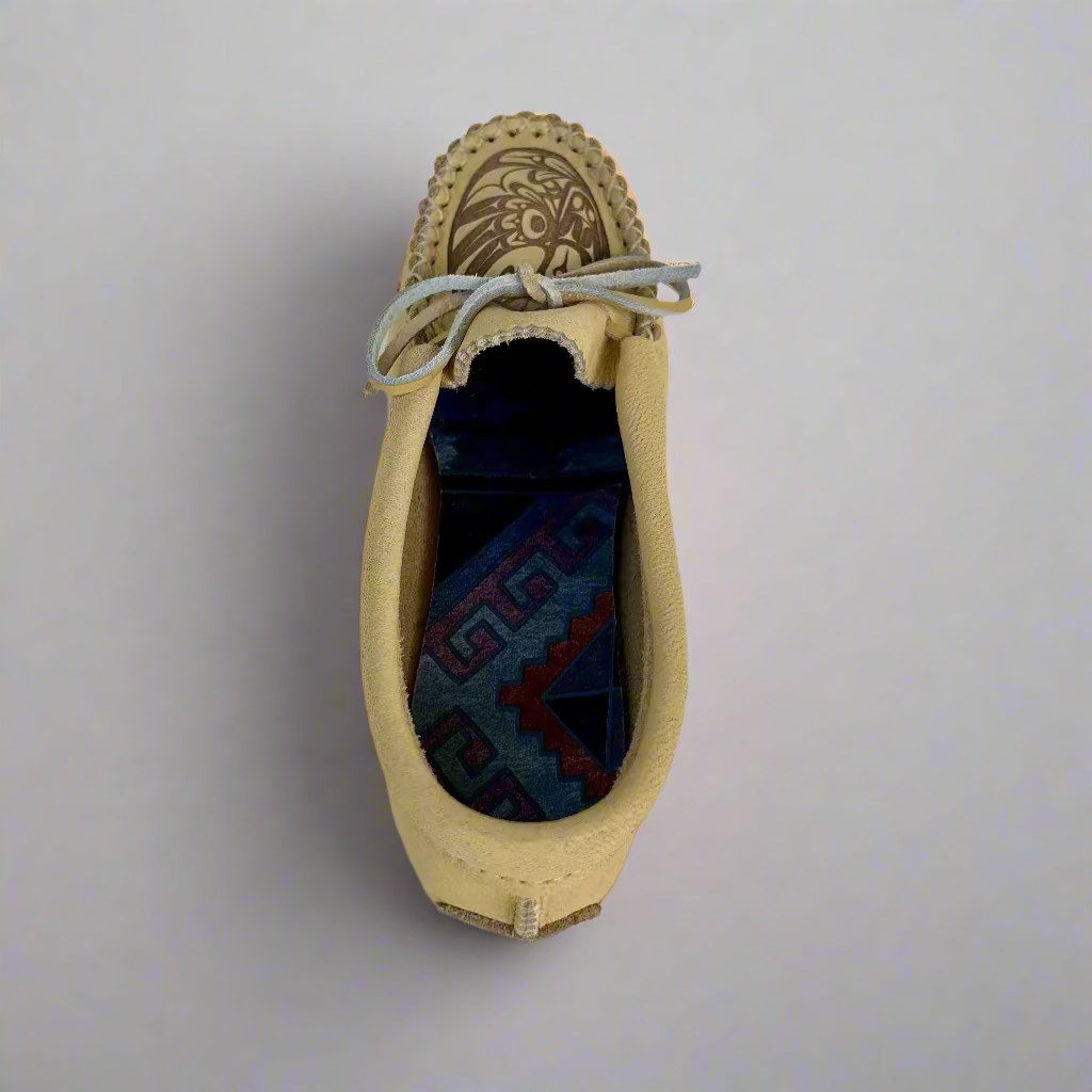 Beige loafer with decorative sole on a light gray background