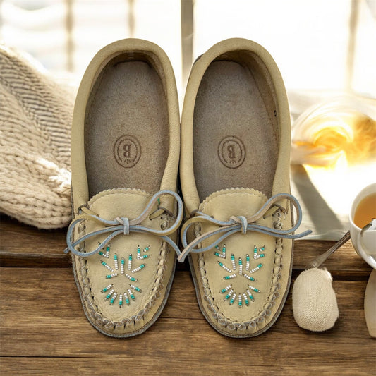 womens leather beaded moccasins on a wooden bench 