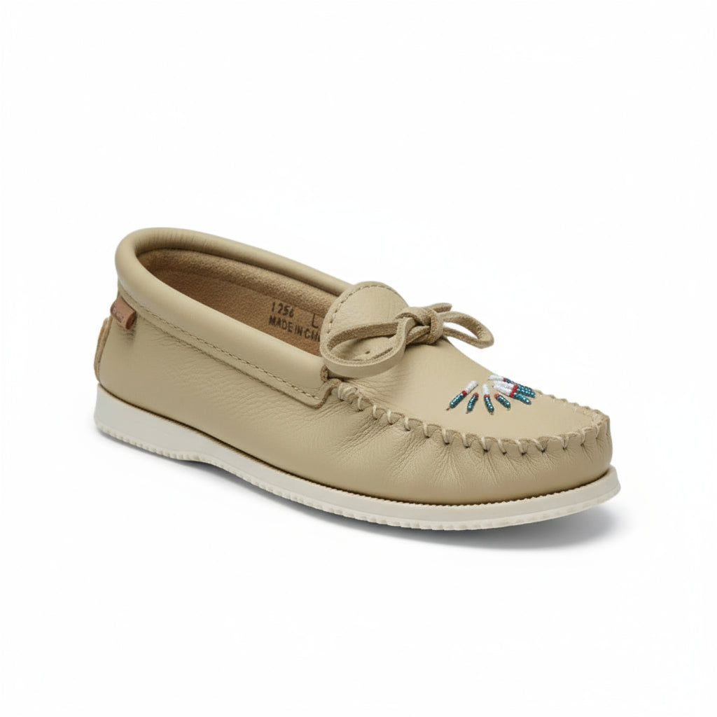 Beige loafer shoe with decorative elements on a white background
