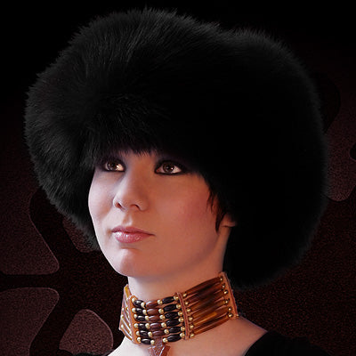 Person wearing a black fur hat and gold necklace with 'Tecumseh Canada' branding.