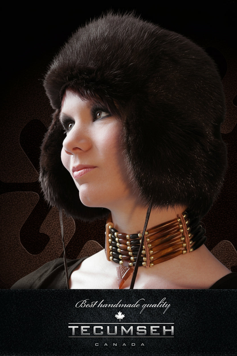 Woman wearing a black fur hat with 'Tecumseh Canada' branding on a dark background