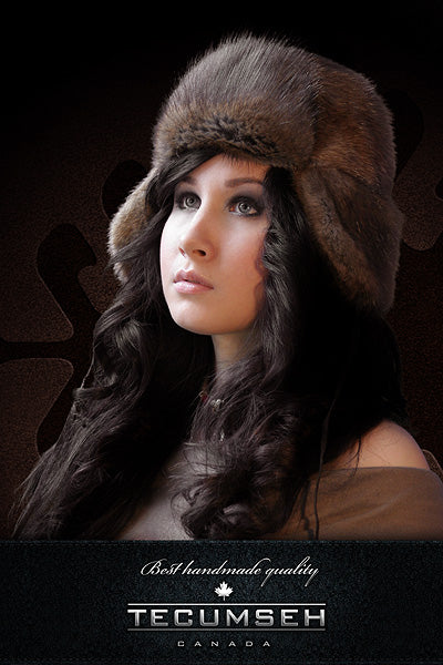 Woman wearing a fur hat with Tecumseh Canada branding on a dark background