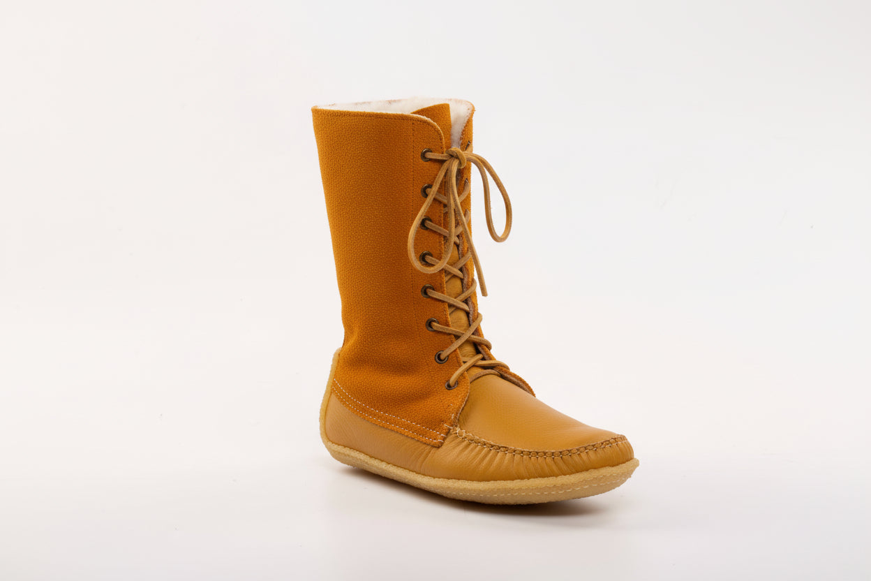 Tan boot with white lining on a white background