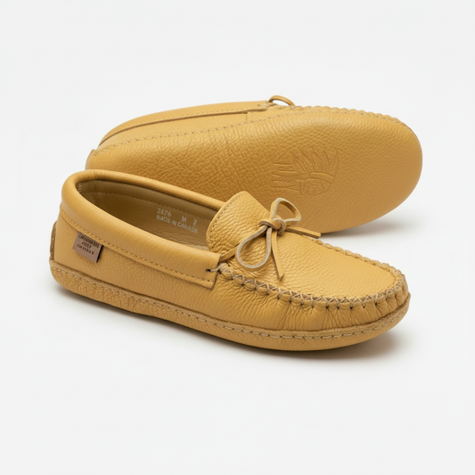 Pair of tan moccasin shoes on a white background