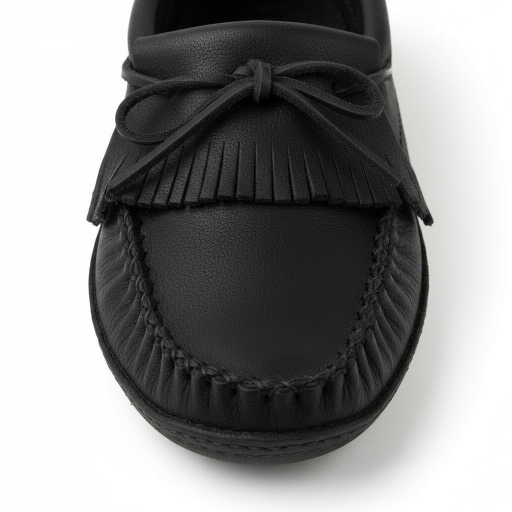 Black moccasin shoe with fringes on a white background