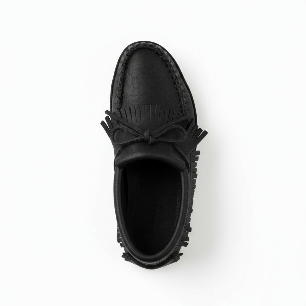 Black loafer shoe with fringes on a white background