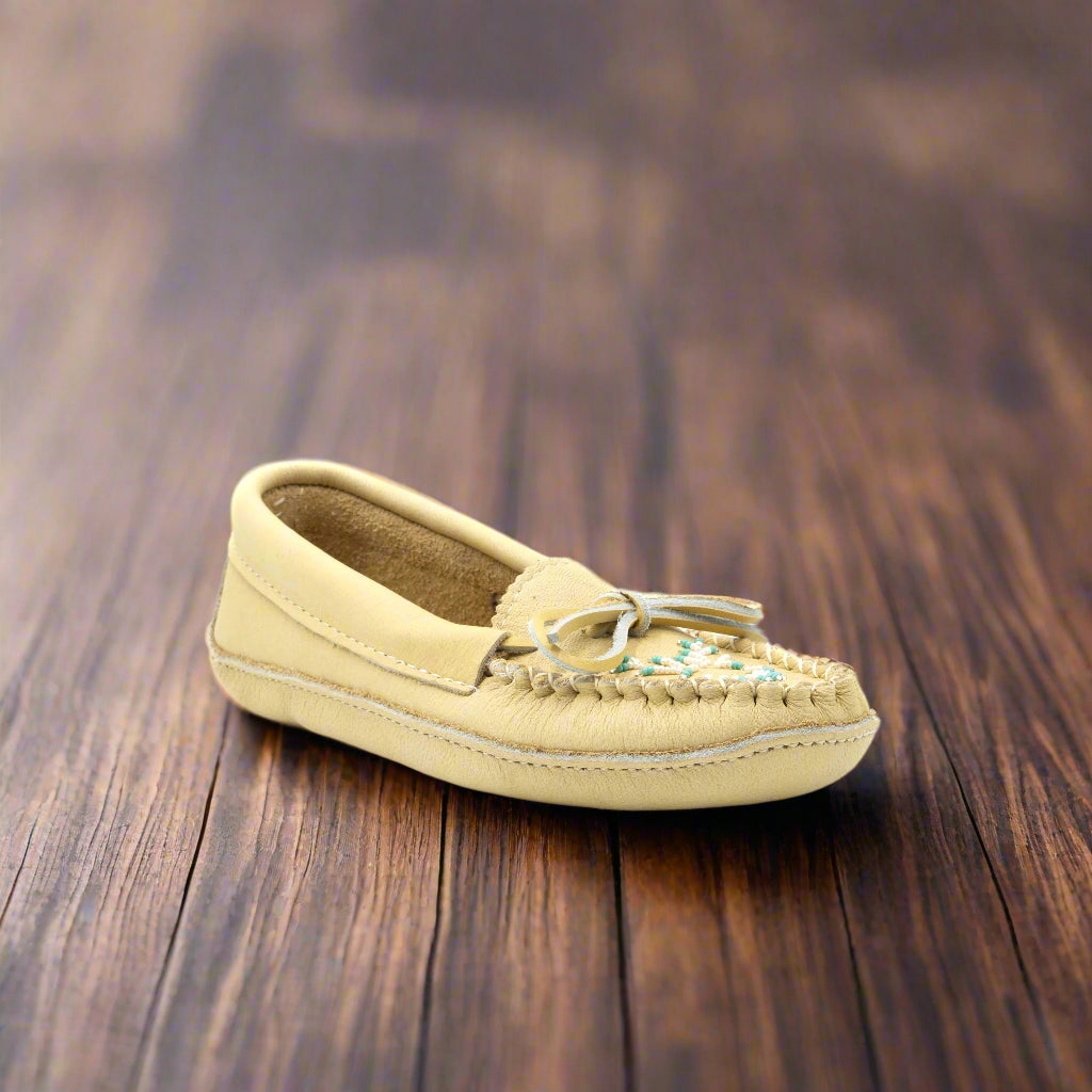Beige moccasin shoe on a white background