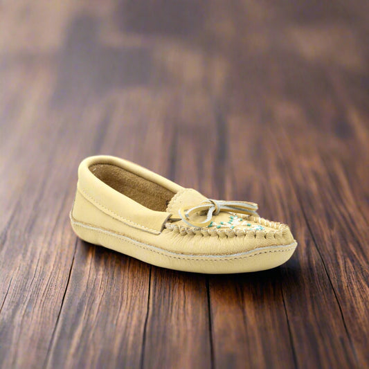 Beige moccasin shoe on a white background