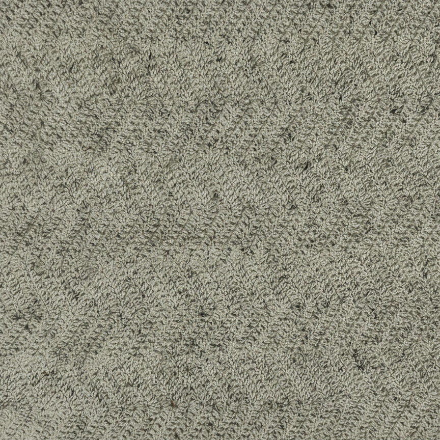 Textured green material swatch on a beige background