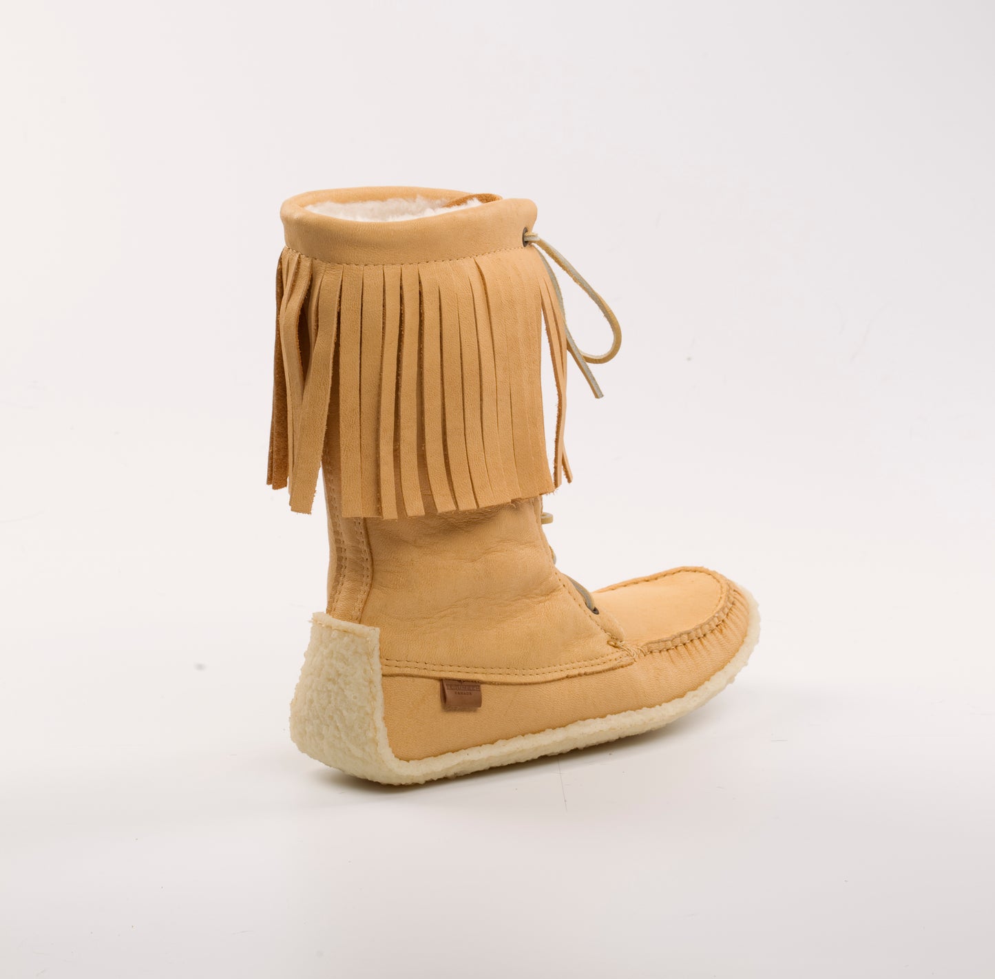 Tan fringed boot on a white background