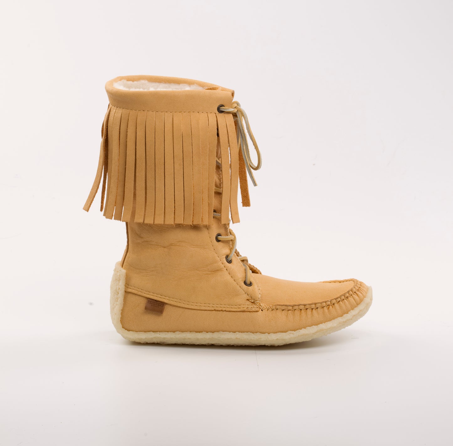 Tan fringed boot on a white background