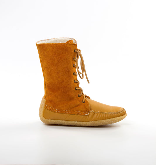Tan boot with sheepskin lining on a white background