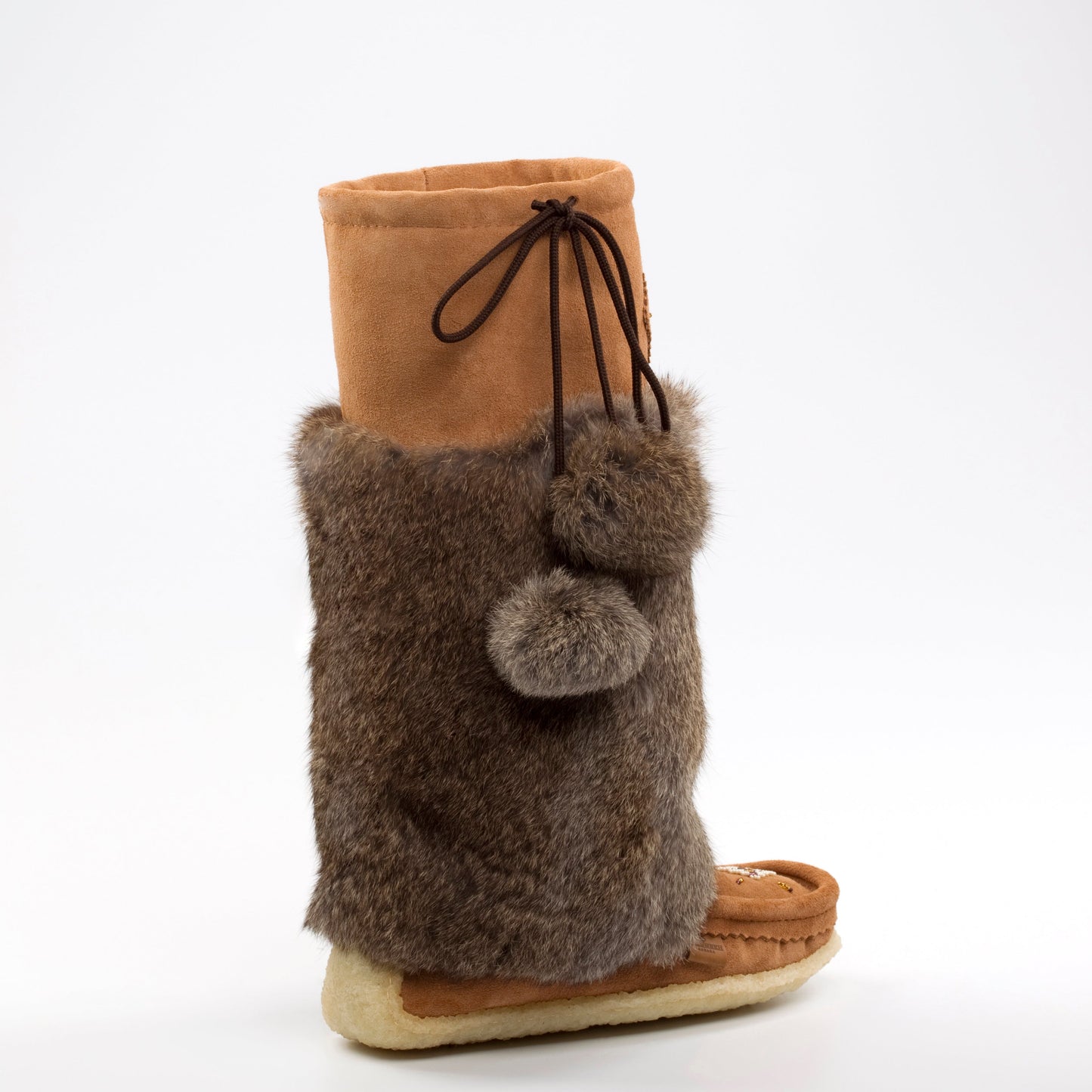 brown mukluk boots on whote background 