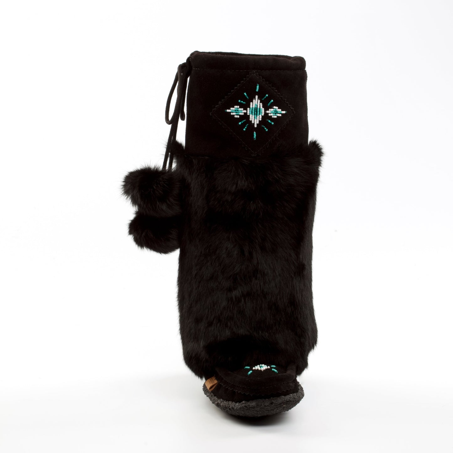 Tecumseh Canada Black fur boot with pom-poms and decorative elements on a white background